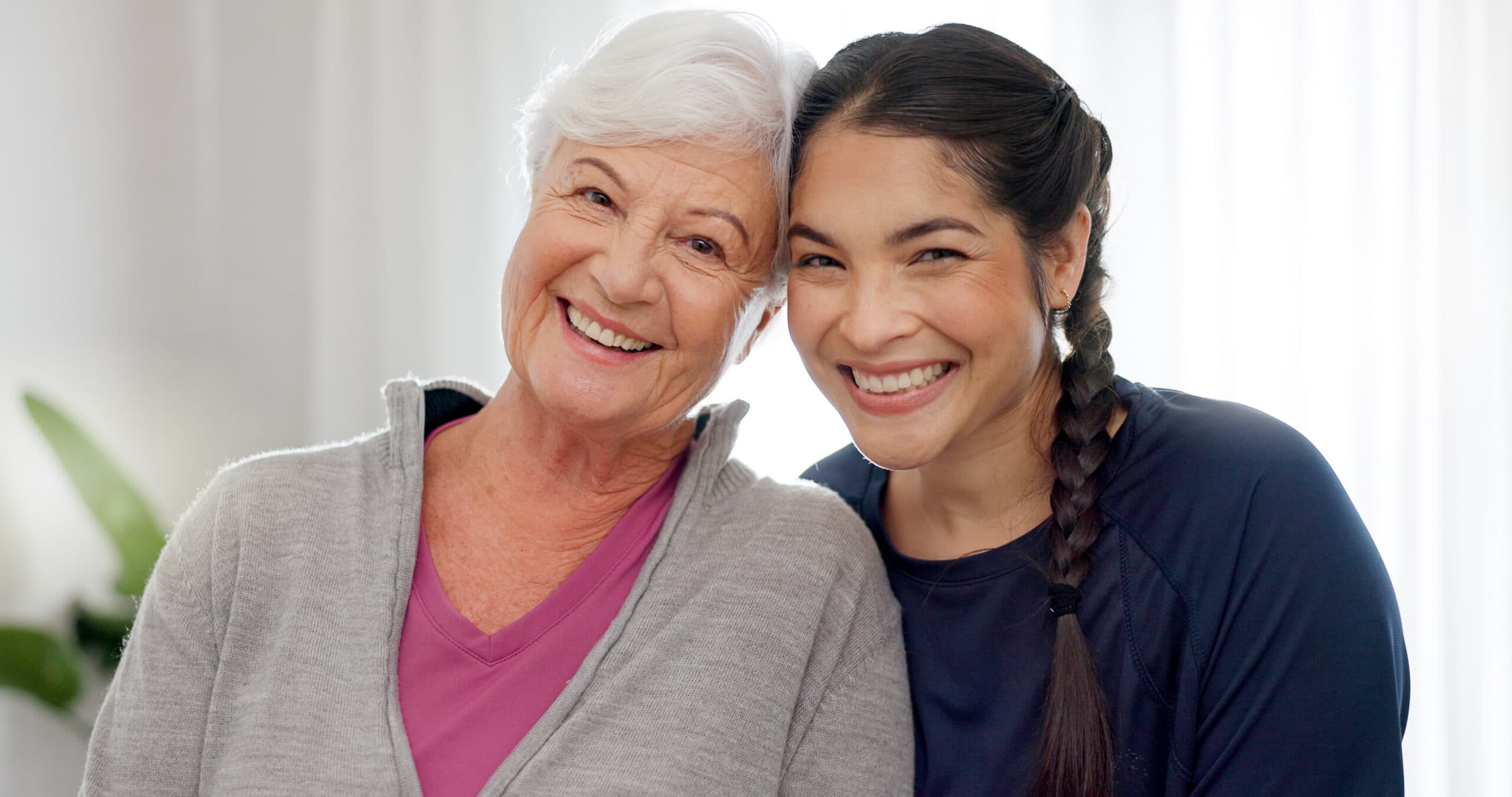 An older woman and a younger woman smiling together