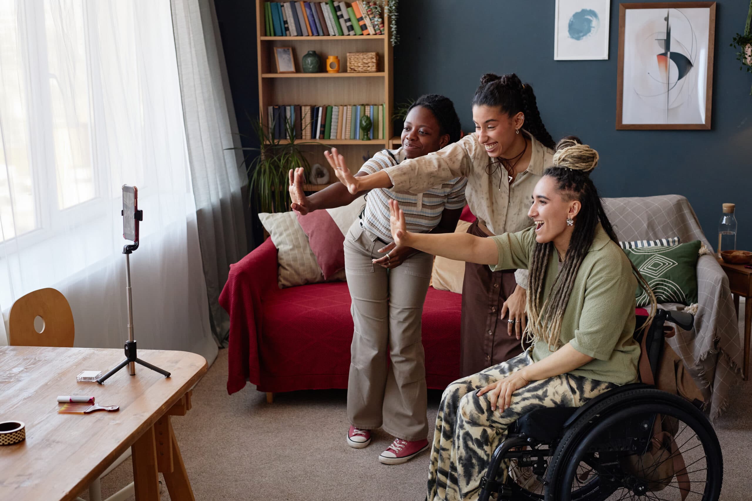 A wheelchair user and a support worker talking in a living room